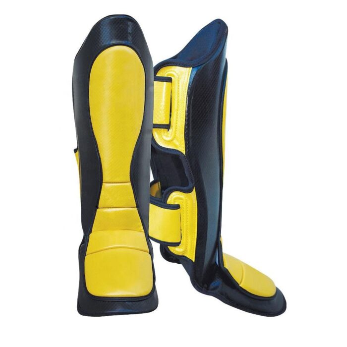 High-quality kickboxing shin instep guard in black and yellow, designed for maximum leg and foot protection during training and competitions.