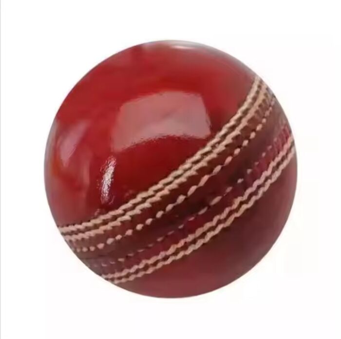 Red leather cricket ball, showing hand-stitched seam and glossy finish.